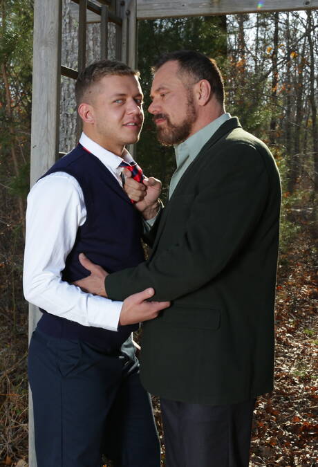 Young Ian Levine in glasses kissing with mature beard gays