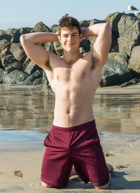 Muscular Archie undressing and showing his ass on beach