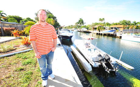 Black husky guy Izzy James and strongman Cole Mckenzie in black on white love on the beach