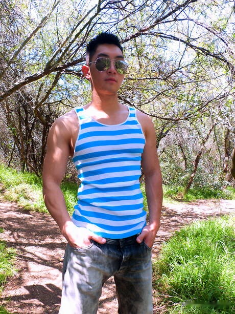 Oriental bodybuilder Eric East posing nude and showing his butt outside